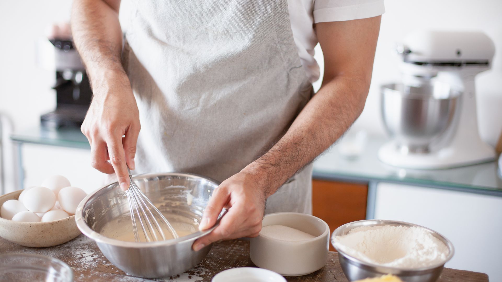 A Person Mixing a Batter using a Wire Whisk