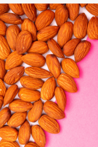 Close-Up Shot of Almond Nuts on a Pink Surface