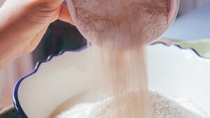 Close-Up Shot of a Person Pouring Flour in a Bowl