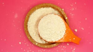 Close-up of Powder in a Bowl and Measuring Spoon