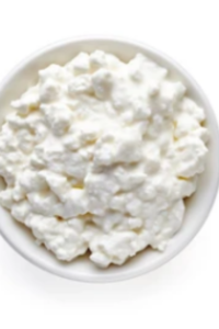 Cottage Cheese on Plates and a Bowl of Sour Cream 