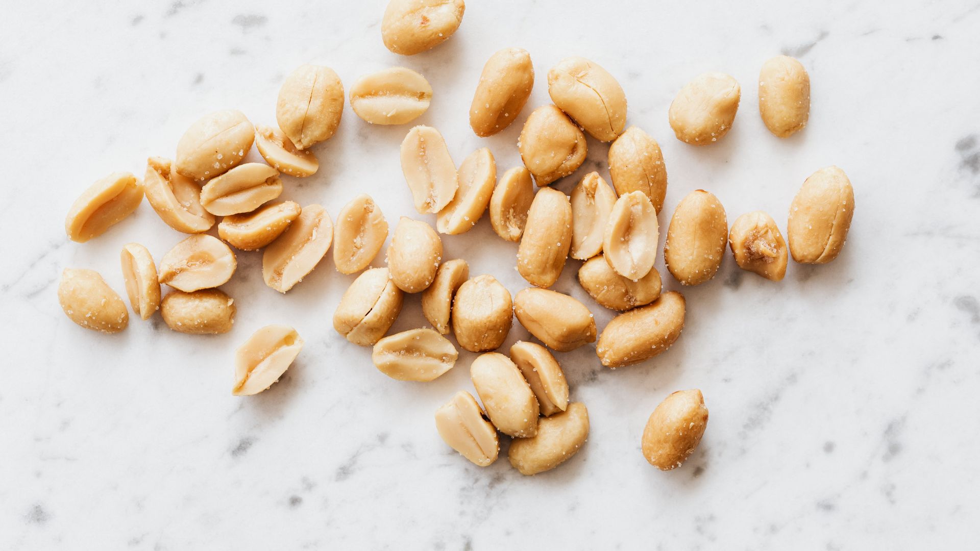 Deshelled Peanuts on White Surface