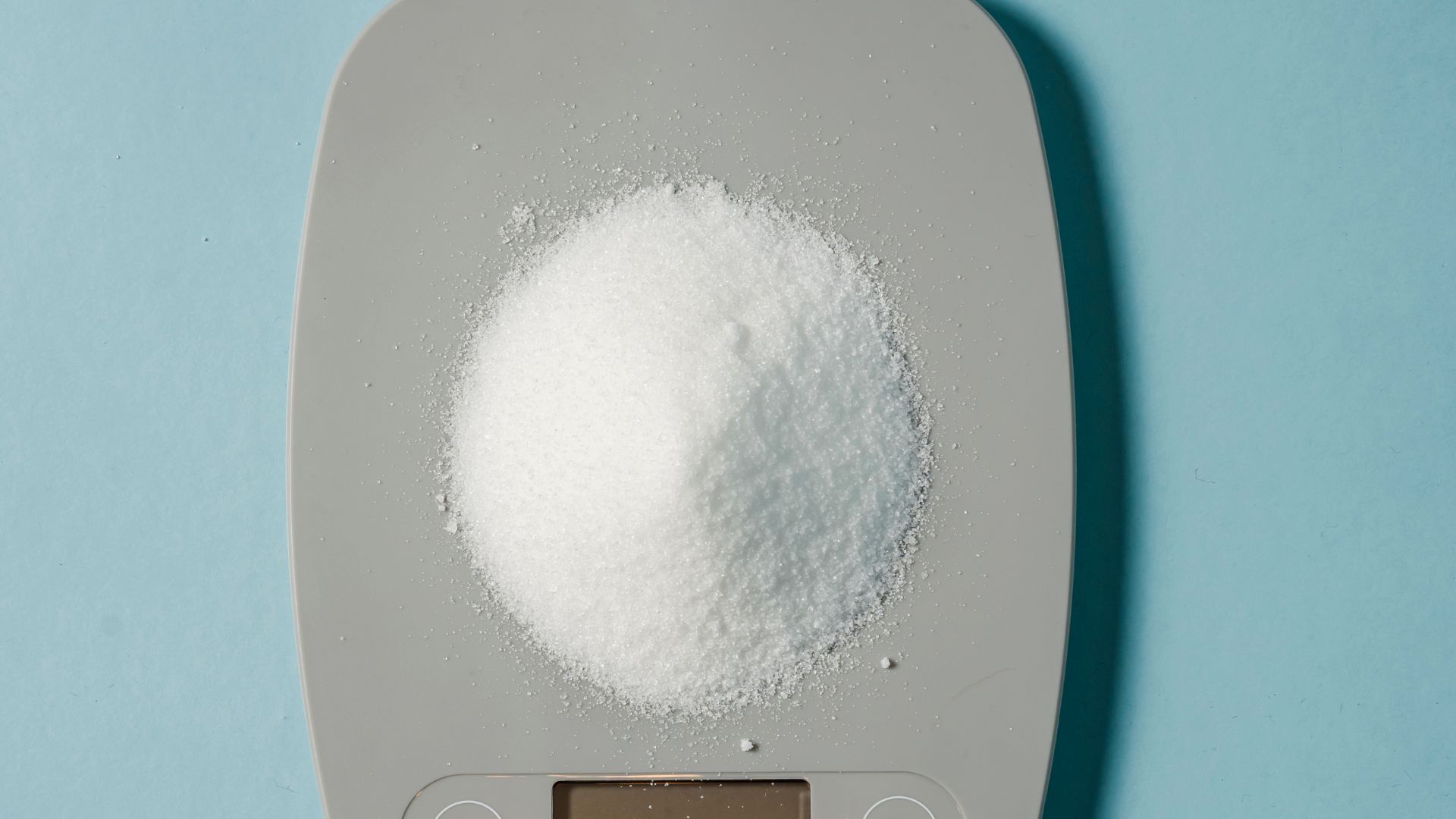 Electronic scales with heap of sugar