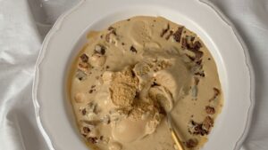 Ice Cream with Chocolate and Hazelnuts on Ceramic Plate