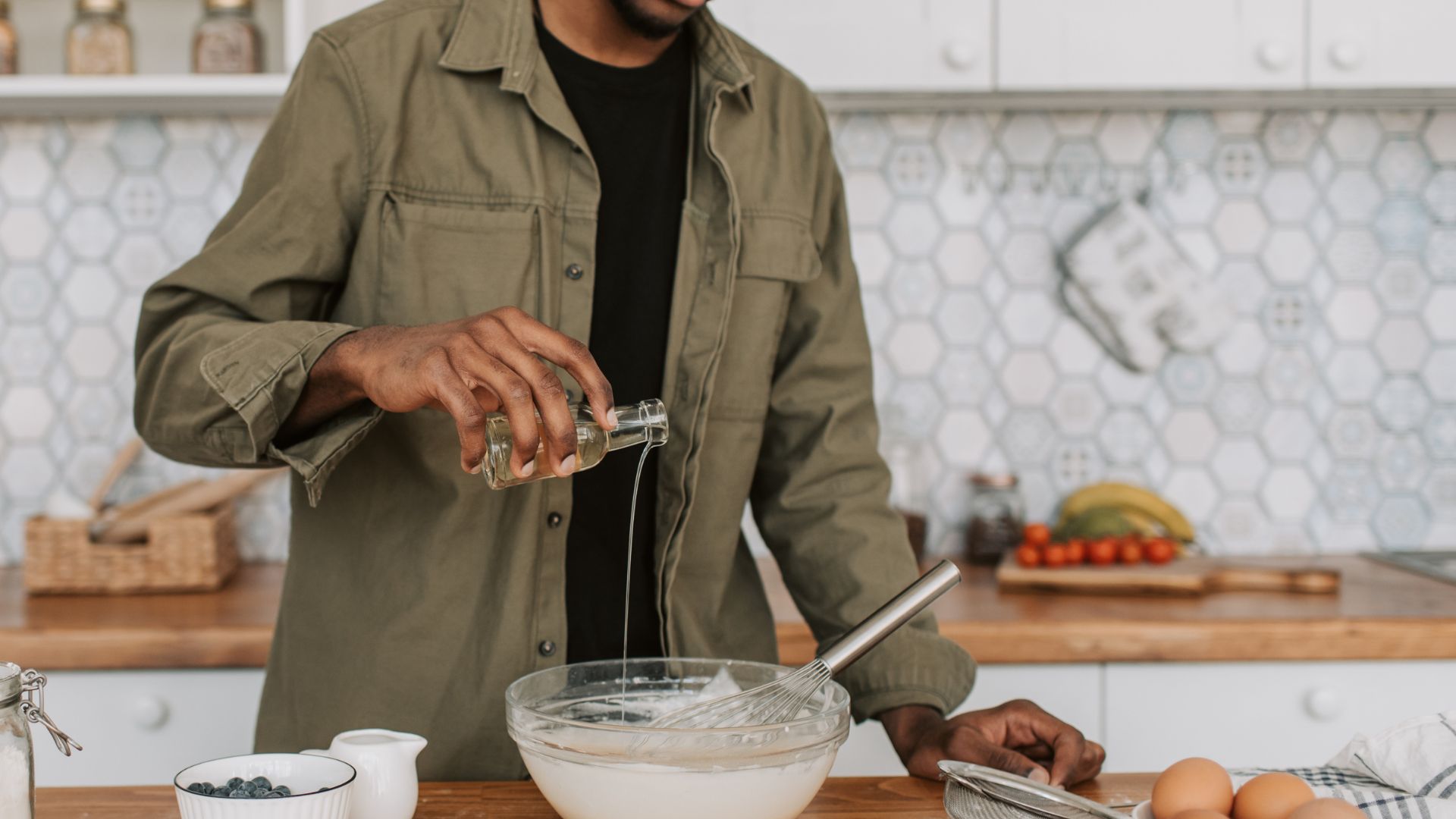 Man in Jacket Pouring Syrup on Bowl