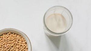 Top View Photo of Soybeans on Bowl Near Drinking Glass With Soy Milk